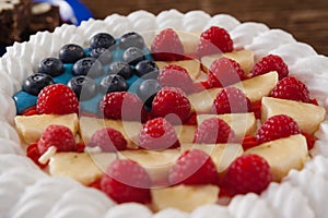 Fruitcake served in plate on wooden table