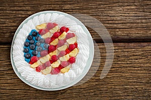 Fruitcake served in plate on wooden table