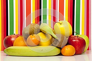 Fruits. Apple, pear, orange, grapefruit, mandarin, kiwi, banana. Multi-color background