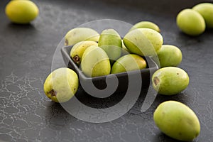 The fruits of the argan tree on a dark background top view close-up. Argania spinosa - Argana