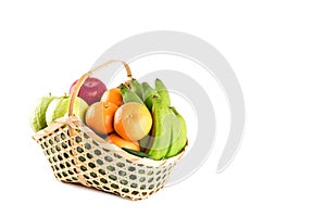 Fruits basket assorted wicker on white background fruit health food isolatedorange, guava, banana and apple in wicker basket on wh