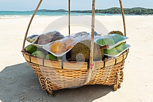 Fruits in a basket: durian , mango. local beach vendor sells food to tourists