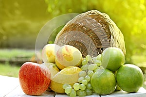 Fruits in a basket. meadow, closeup.