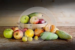 Fruits and basket on wooden table,