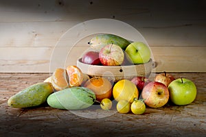 Fruits and basket on wooden table,