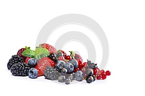 Fruits and berries isolated on white background. Ripe currants, blackberries, blueberries and strawberries with a mint leaf. Sweet