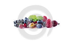 Fruits and berries isolated on white background. Ripe currants, blueberries, raspberries and gooseberries with a leaf of mint. Swe