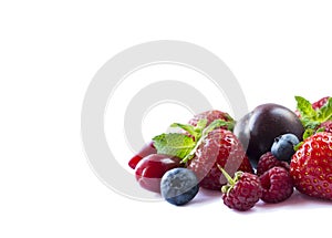 Fruits and berries on white background. Ripe strawberries, blueberries, raspberries, red berries and plums. Mix fruits on white. M