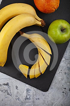 Fruits on a black slate board