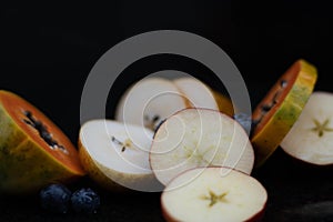 Fruits close up on black stone background