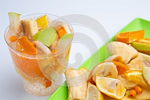 Fruits coctail, water drink on light grey background