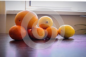 Fruits composition. Orange and lemon on table. Yellow orange brown whhite collors use in photo.