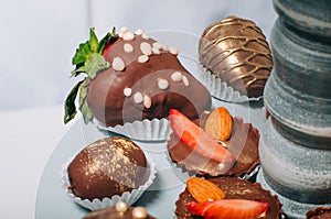 Fruits covered with chocolate decorated with puffed rice