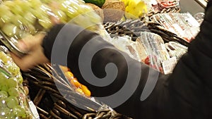 Fruits and dried fruits in the store, in packaging, a woman chooses. Supermarket , fruit and vegetable zone