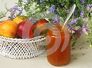 Fruits, flowers and jam on the table
