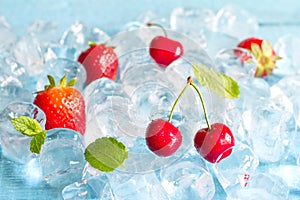 Fruits in ice cubes with cherry and strawberry