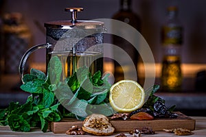 Fruits and kitchen herbs with tea pot still life in the kitchen