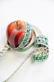 Fruits and measurement tape on the white background