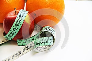 Fruits and measurement tape on the white background