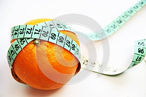 Fruits and measurement tape on the white background