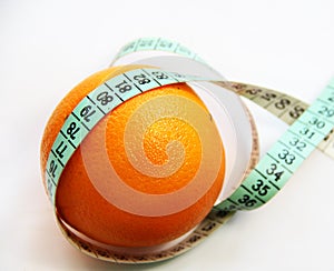 Fruits and measurement tape on the white background