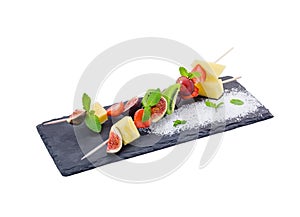 Fruits pieces mix on skewer. Isolated.