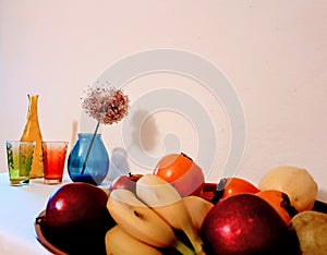 Fruits on plate with glass ,vase still life ,apples , bananas ,pears ,photo art
