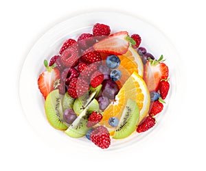 Fruits. Plate of mixed fruits and berries on white background. Fresh food. Top view