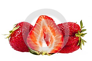 Fruits of red cut strawberries isolated on white background
