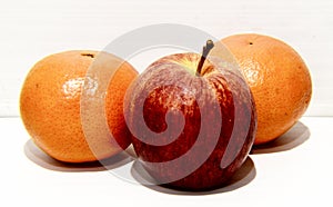 Fruits: tangerines and aplles on a Light background