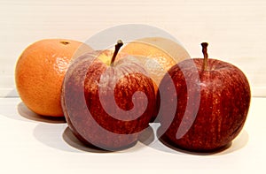 Fruits: tangerines and aplles on a Light background