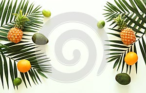 Fruits top view background. tropical green palm leaves branches and fruits pineapples