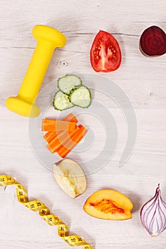 Fruits and vegetables, dumbbell and tape measure, healthy lifestyles concept
