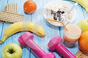 Fruits, vegetables, juice, smoothies and dumbbells health diet and fitness lifestyle concept.