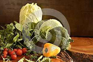 Fruits and vegetables like tomatoes, yellow bell pepper, broccoli, parsley arranged in a group, natural still life for healthy