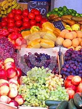Fruits and vegetables at the market . Grapes, bananas, peachs and more