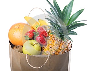 Fruits and vegetables in paper grocery bag isolated over white