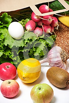 Fruits, vegetables and products in a paper grocery bag