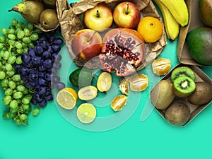 Fruits and vegetables rich in antioxidants, vitamin and fiber on trendy mint green background. Flat lay style. Super food