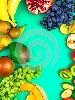 Fruits and vegetables rich in antioxidants, vitamin and fiber on trendy mint green background. Flat lay style. Super food