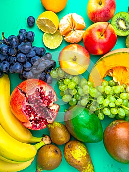 Fruits and vegetables rich in antioxidants, vitamin and fiber on trendy mint green background. Raw, vegan, vegetarian, alkaline