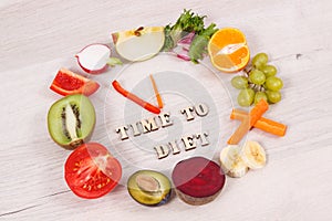 Fruits and vegetables in shape of clock showing time to diet, healthy eating containing vitamins