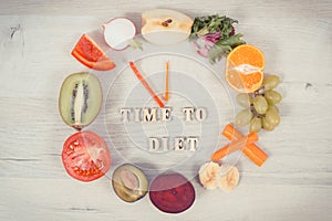 Fruits and vegetables in shape of clock showing time to diet, healthy eating containing vitamins