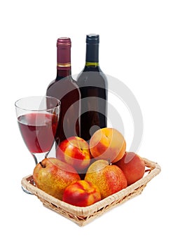 Fruits, wine bottles and a wine glass on a white background