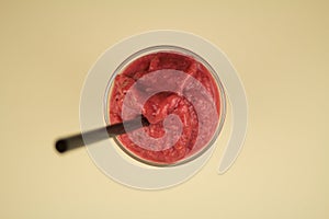 Fruitshake in a Glass with a Straw, shot from above. photo