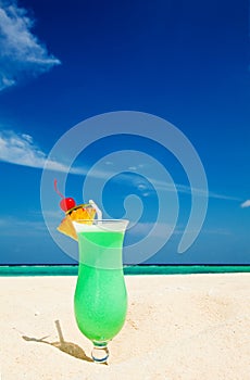 Fruity cocktail is on a beach
