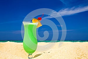 Fruity cocktail is on a beach