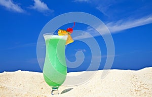 Fruity cocktail is on a beach