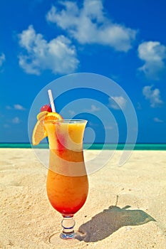 Fruity cocktail is on a beach