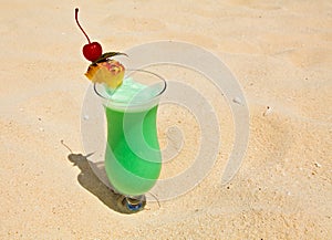 Fruity cocktail is on a beach